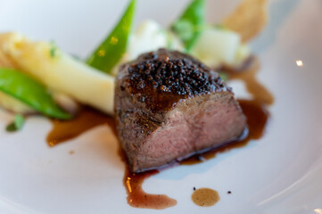 Roasted beef tenderloin served with white asparagus in gastronomic restaurant