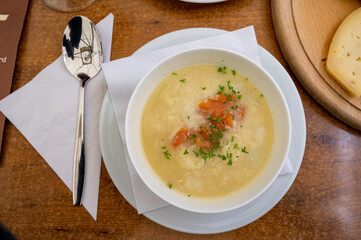 Seasonal dish, white asparagus cream soup with smoked salmon fish
