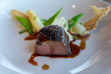 Roasted beef tenderloin served with white asparagus in gastronomic restaurant