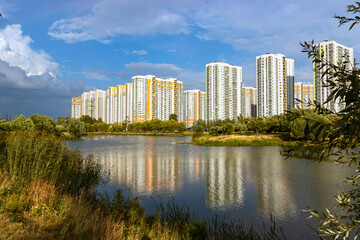 Fototapeta na wymiar New multi-storey houses on the banks of the river. New district. Development.