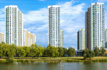 Fototapeta premium High-rise multi-storey buildings of the new district of the big city. Ecologically clean area. Bank.