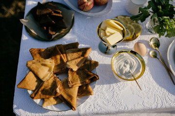 Pancakes in a breakfast plate. Laid breakfast table. Pancake butter