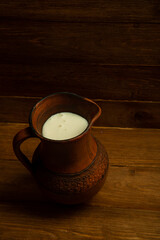 large clay jug with fresh milk and cream. Fresh ingredients for cheese production. concept is cheese handicraft production, restaurant.