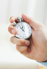 Man Holding Analog Stopwatch. Closeup Of Business Man Holding Stop Watch In His Hand
