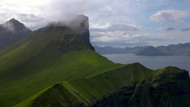Beautiful aerial footages of the Kallur Light house in the Faroe Islands, and its massive cliffs, crags hikes and ocean views