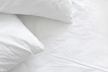 Hypoallergenic pillow in pillowcase over white linen sheets