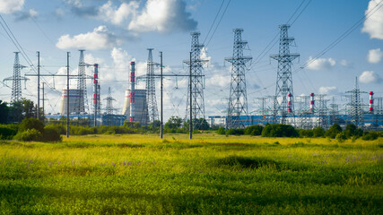 power station and pylons with wires on the field