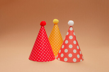 Colorful birthday cap on brown  background.