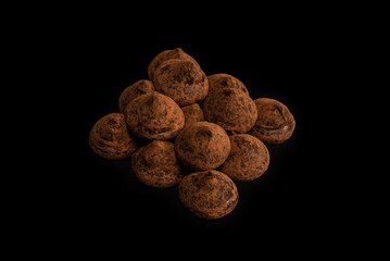Chocolate truffles on a black background.
