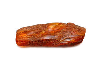 A piece of oblong amber on a white background. Polished semi-precious colored mineral. Material for jewelry. Copal. Ancient fossil resin. Sun stone. Crystal. Geology and minerals 