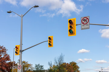 Traffic lights against blue sky on street of Ottawa city in Canada in autumn