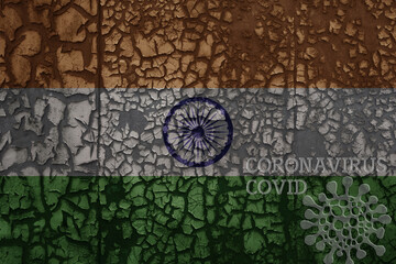 flag of india on a old metal rusty cracked wall with text coronavirus, covid, and virus picture.