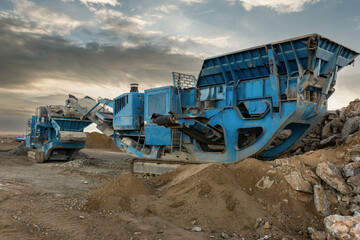 Heavy and mobile machinery in a quarry to transform stone into construction material