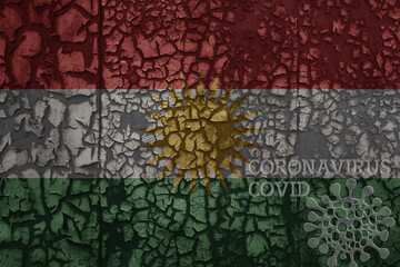 flag of kurdistan on a old metal rusty cracked wall with text coronavirus, covid, and virus picture.