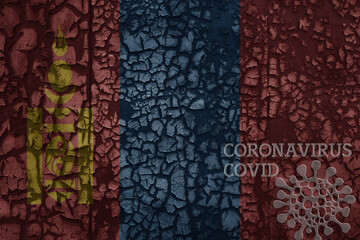 flag of mongolia on a old metal rusty cracked wall with text coronavirus, covid, and virus picture.