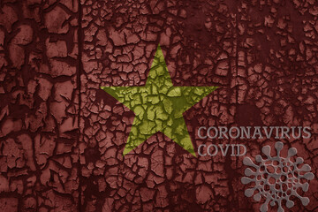 flag of vietnam on a old metal rusty cracked wall with text coronavirus, covid, and virus picture.