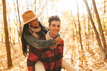 Young beautiful couple in the autumn garden at fall.
