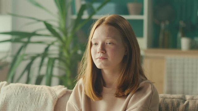 Portrait of a Sad, Depressed Red-haired Teenage Girl with Sad Eyes. Portrait of Teenage Depression. Negative Bad Mood Concept. Mental Health.