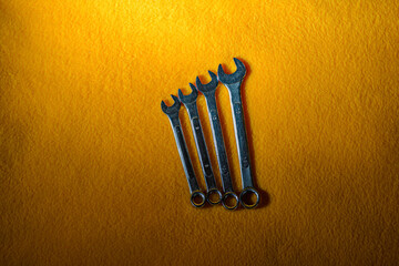 Horn-cap wrenches on a yellow fabric background