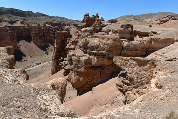 Canyon, panoramic sunlit view with rocks and road