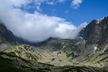Obraz premium Mountain landscape in Slovakia, rocky mountain valley and climbing rocks with cloudy sky in the national park High Tatras
