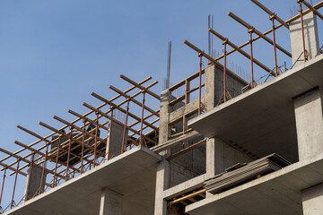 Construction of a new residential monolithic-frame house in the city using a truck crane