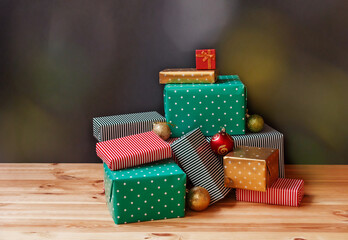Colorful gifts and christmas balls on dark background
