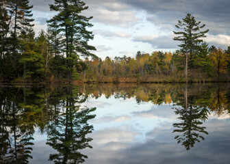Fototapeta na wymiar Sunset reflections on a secluded Northwoods lake in autumn.