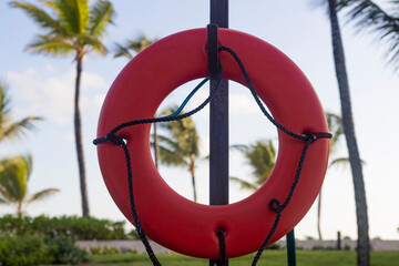 ORANGE LIFEGUARD HANGED FROM POST IN BEACH AREA