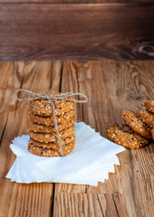 Fototapeta premium Homemade cookies with seed pieces, laid out in a stack on the stem on a tree table.
