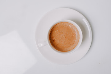 Cup full of coffee on white background.