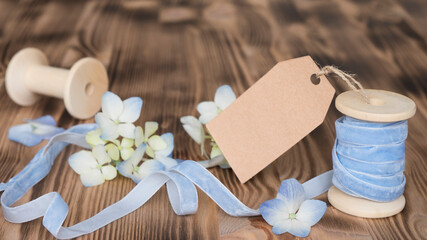 Delicate composition with blue hydrangea flowers on wooden background. Image with selective focus