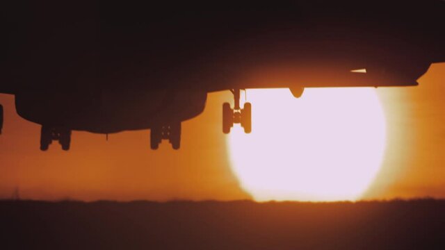 Large passenger jet landing at sunset. 4k footage.