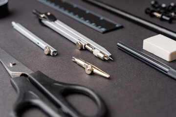 Drawing accessories lie on a black background.