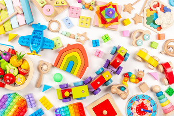 Baby kids toys background. Many colorful educational wooden, plastic toys on white background. Top view, flat lay