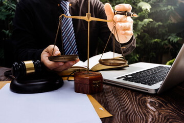 Business and lawyers discussing contract papers with brass scale on desk in office. Law, legal services, advice, justice and law concept picture with film grain effect