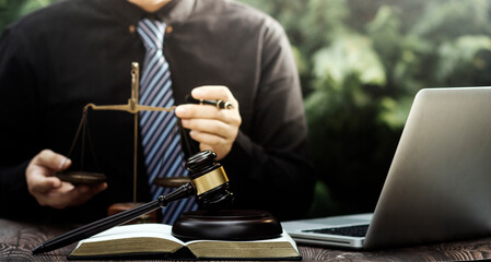 justice and law concept.Male judge in a courtroom on wooden table and Counselor or Male lawyer working in office. Legal law, advice and justice concept.