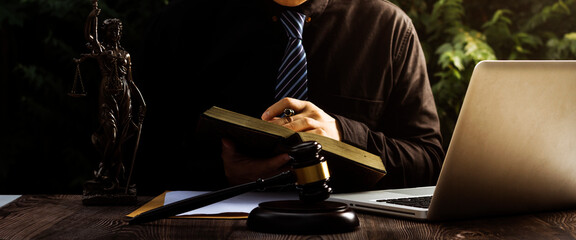 justice and law concept.Male judge in a courtroom on wooden table and Counselor or Male lawyer...