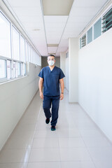 Doctor walking trough a hospital hall