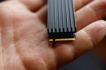 The service technician holds a new ssd drive in his hands. Close up.