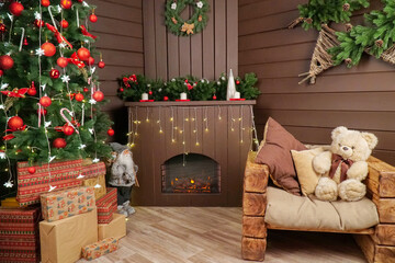 New Year's room decor. fireplace Christmas tree wooden chair bear