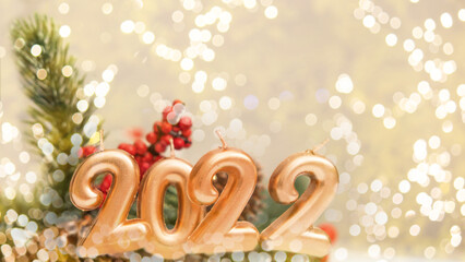 christmas figures 2022 on white wooden background with bokeh, christmas concept