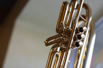 The valve system of a lacquered subcontrabass trumpet