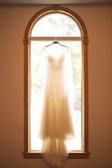 Detail shots of a wedding dress before the bride starts getting ready to be married on her wedding day.