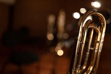 A part of a lacquered trombone in stage lights and bokeh. A brass instrument common to classical...