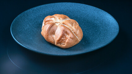 fresh sweet bun on dark plate as food background