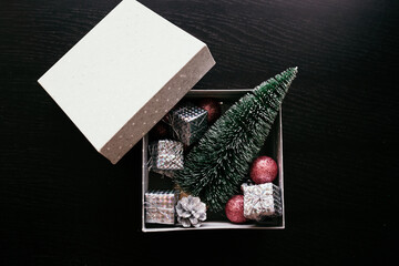 gift box with Christmas toys on a black background with a place for text