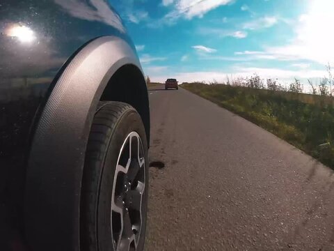 two crossovers driving down the autumn road