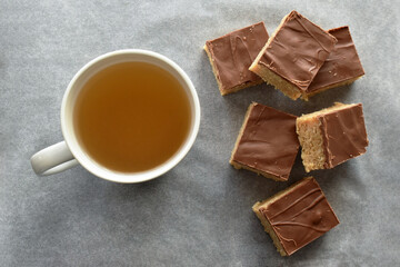 Chocolate caramel rice crispy treats on parchment paper.