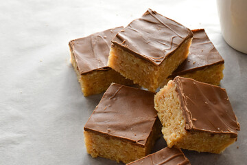 Chocolate caramel rice crispy treats on parchment paper. 